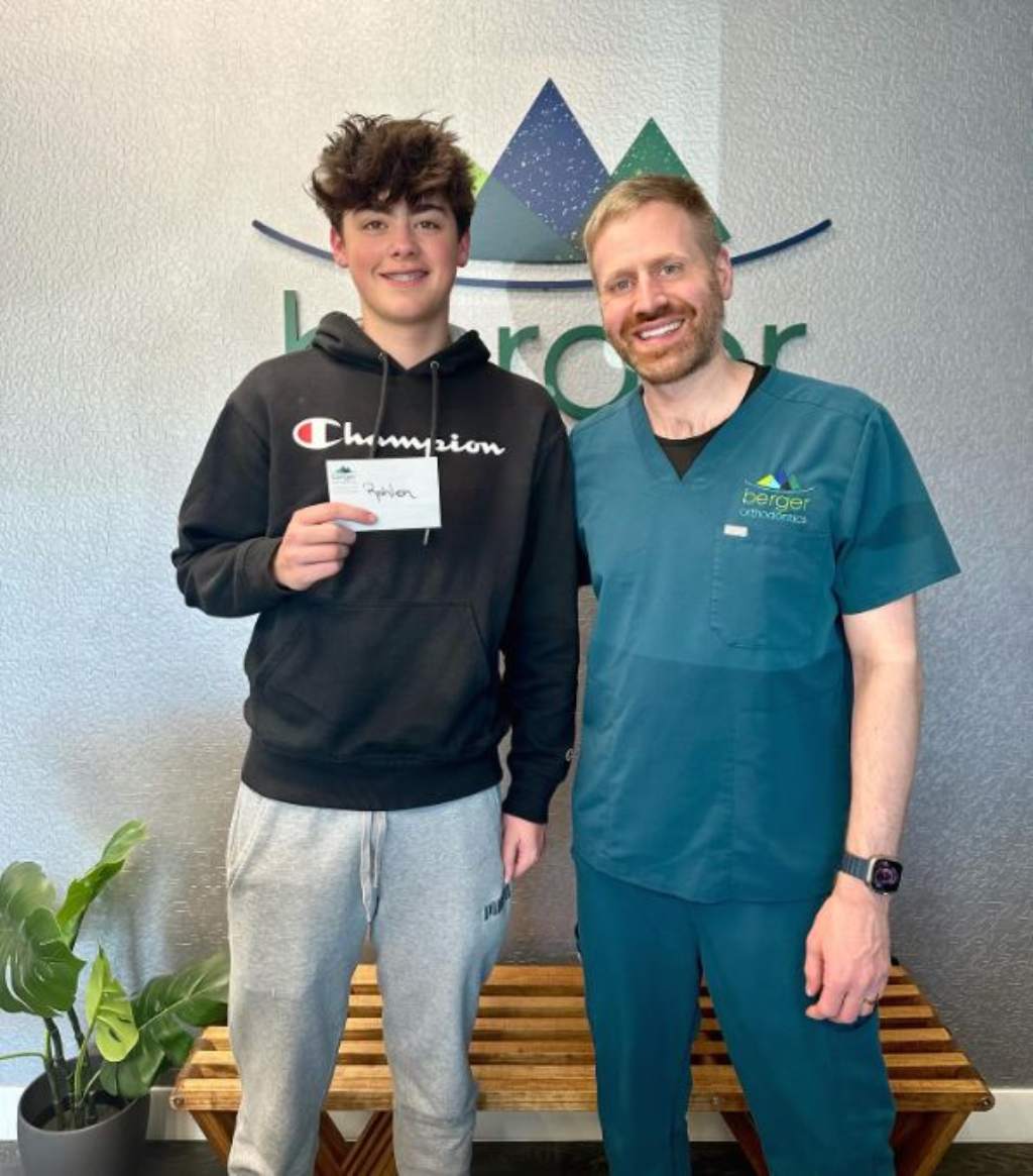 The orthodontist smiling with a patient